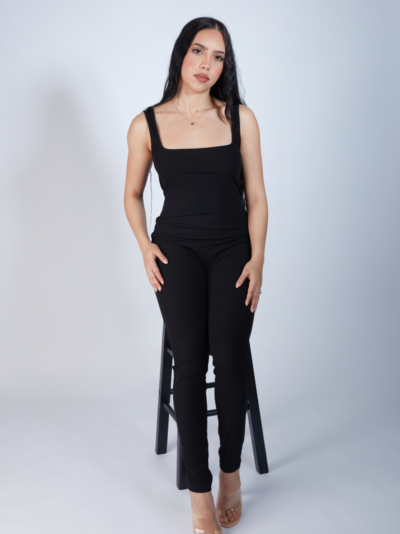 Black rib knit fabric jumpsuit with a sophisticated scoop neck design, Sleeveless scoop neck jumpsuit in chic black, crafted from rib knit material, zade fashion
