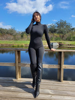 long black jumpsuit, long sleeve black jumpsuit, long pants black jumpsuits, knee high heel boots, INSTAGRAM photoshoot pose ideas, sexy beautiful latina dominican women wearing a full long sleeve long pants bodysuit with sexy high heel knee high boots, Justfab knee high leather boots with pointy front, zade fashion