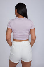Zade Fashion pink crossover crop top with elegant chest cutout design, short sleeves and mock neck detail. Stretchy fitted silhouette perfect for night out or festival wear.