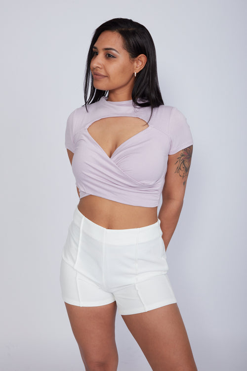 Zade Fashion lilac wrap crop top featuring unique chest cutout detail and asymmetrical neckline. Soft stretchy fabric ideal for stylish summer outfits.